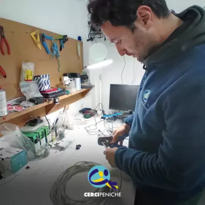 Coloborador da Cercipeniche em contexto de trabalho. Logo da Cercipeniche.