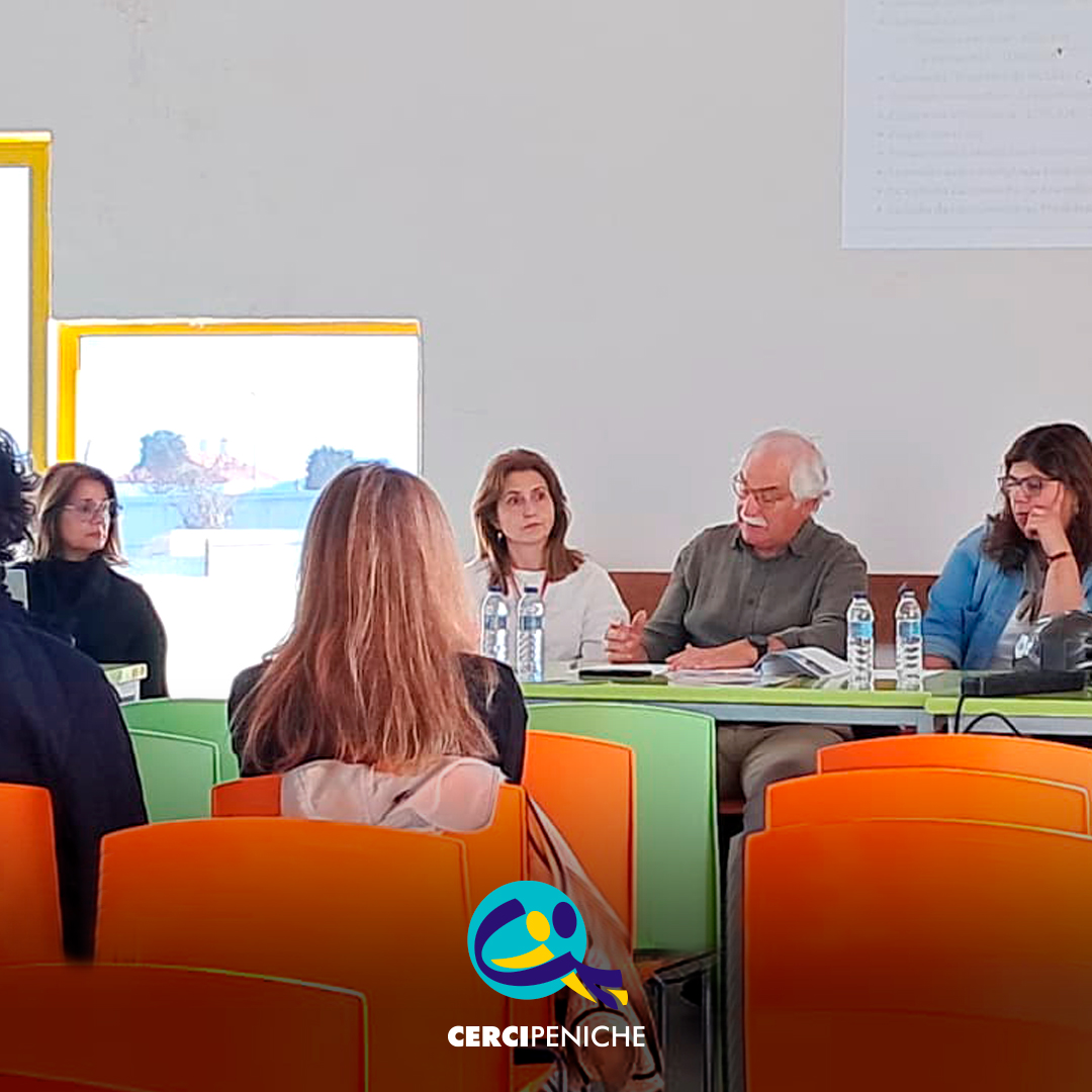 Foto com membros da Assembleia Geral e algumas pessoas a assistir, que se realizou no dia 31 de março na sede da Cercipeniche. Logo da Cercipeniche.